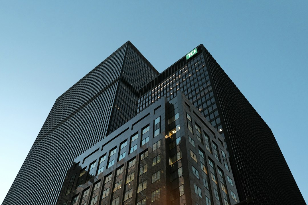 Modern glass skyscrapers rising against a clear blue sky